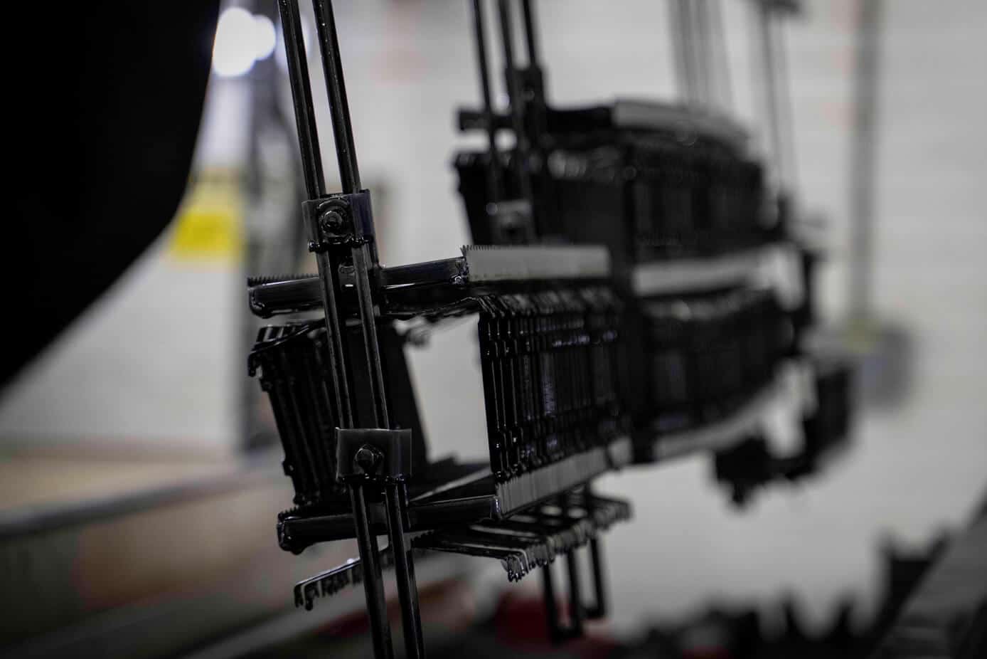 Phosphate Automotive parts racked on a jig for phosphate coating