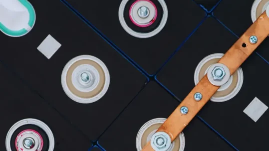 High-power copper busbar connecting electric vehicle battery cells.