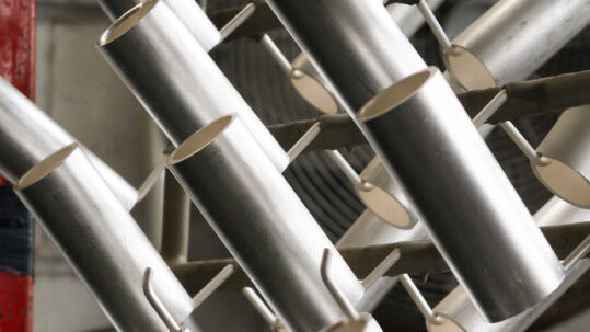 Some plated components hanging on a metal frame
